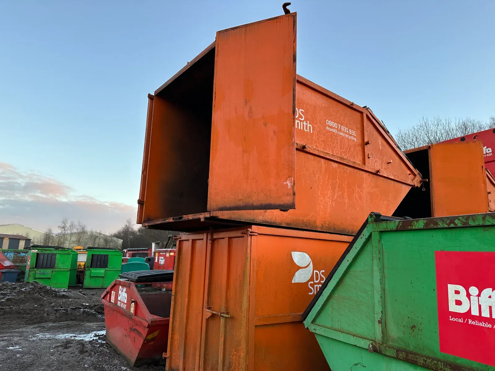 Refurbished containers stacked in the yard, ready to go back to the customer