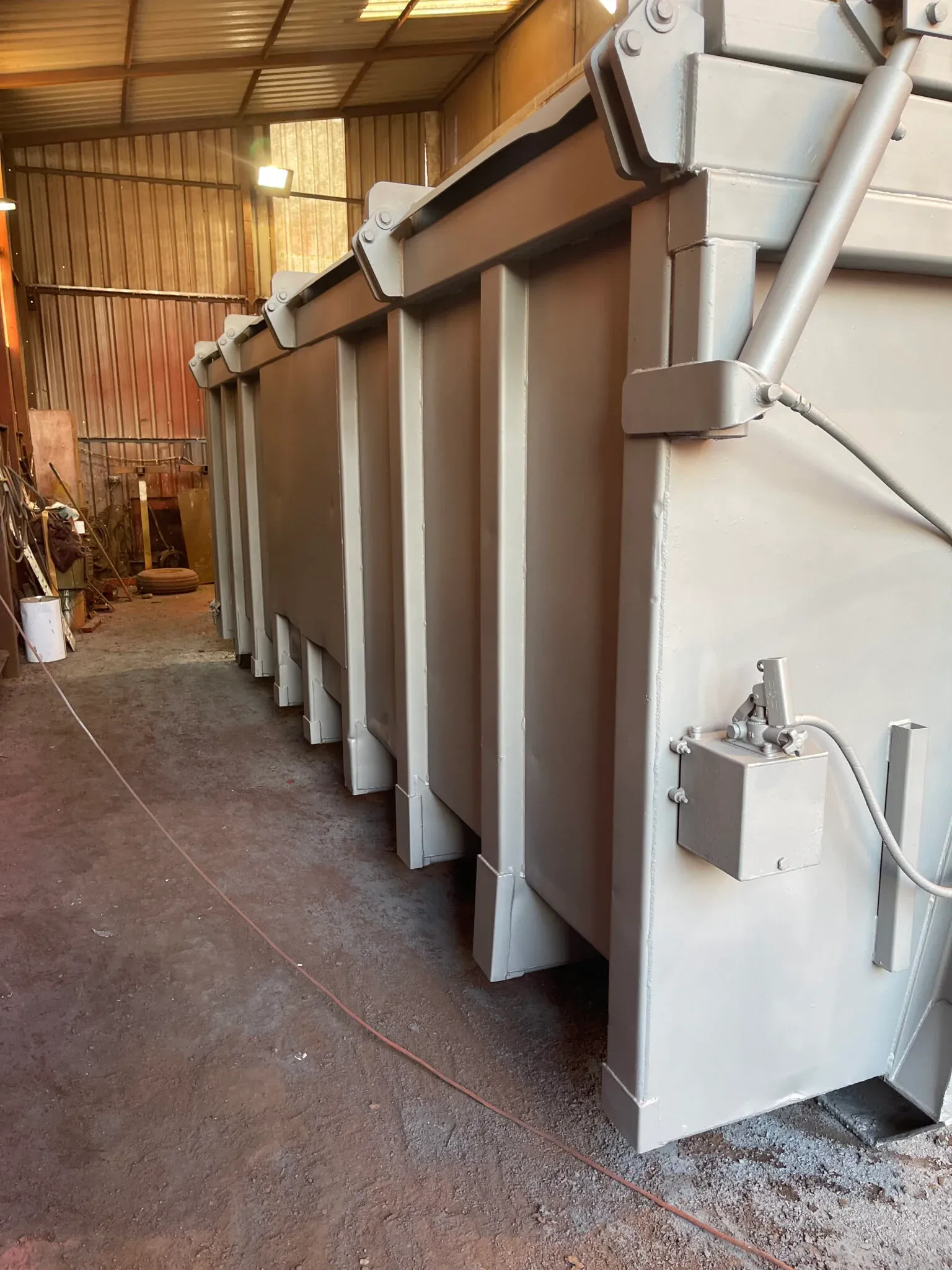 A roll-on roll-off container receiving its protective coating in the workshop