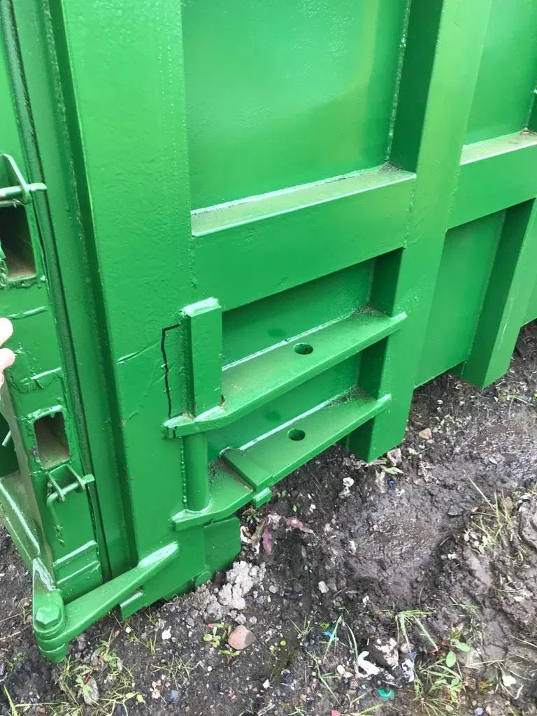 Close-up of a container's freshly resprayed green paintwork