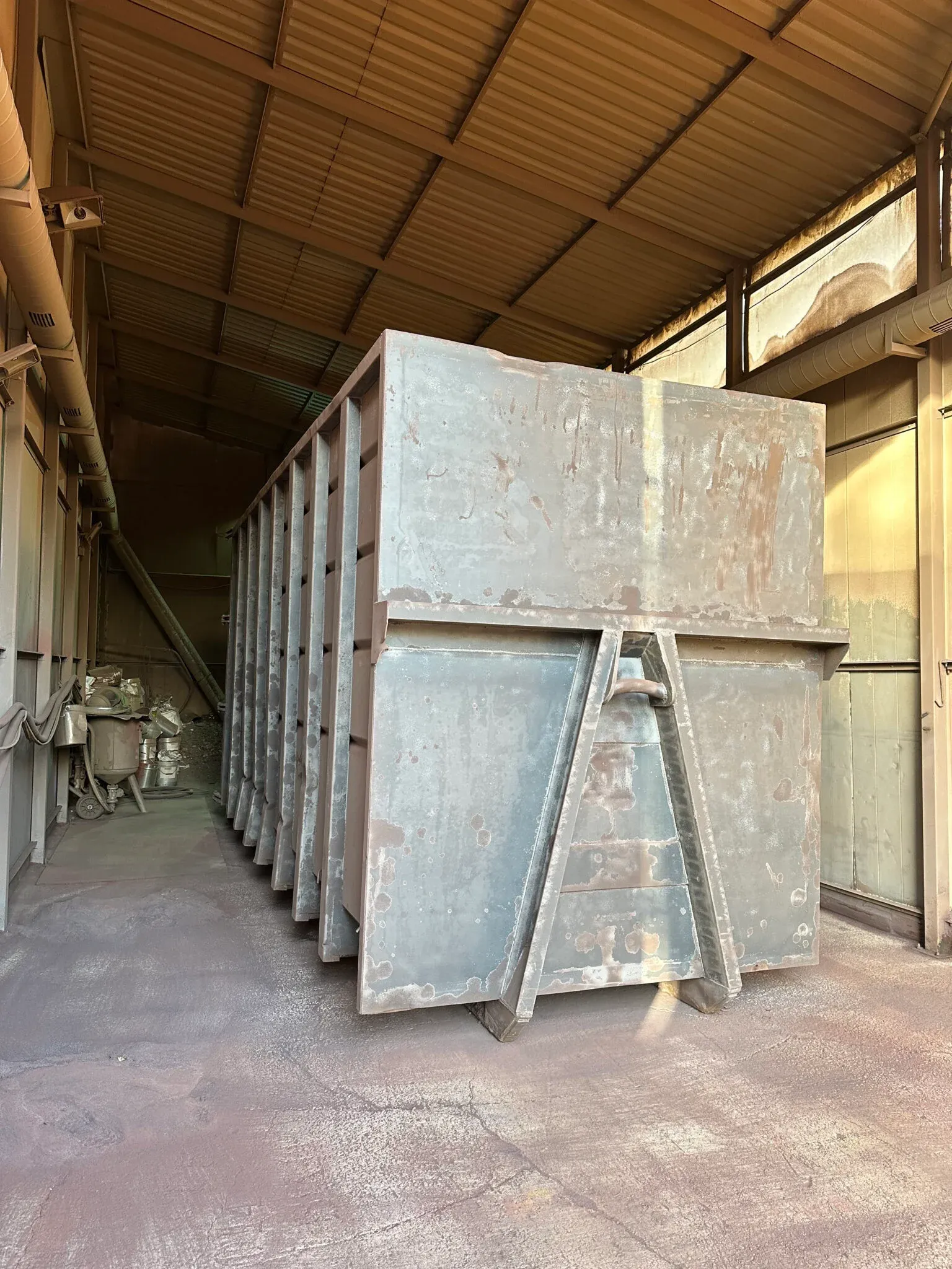 A roll-on roll-off container stripped back to bare steel in the workshop